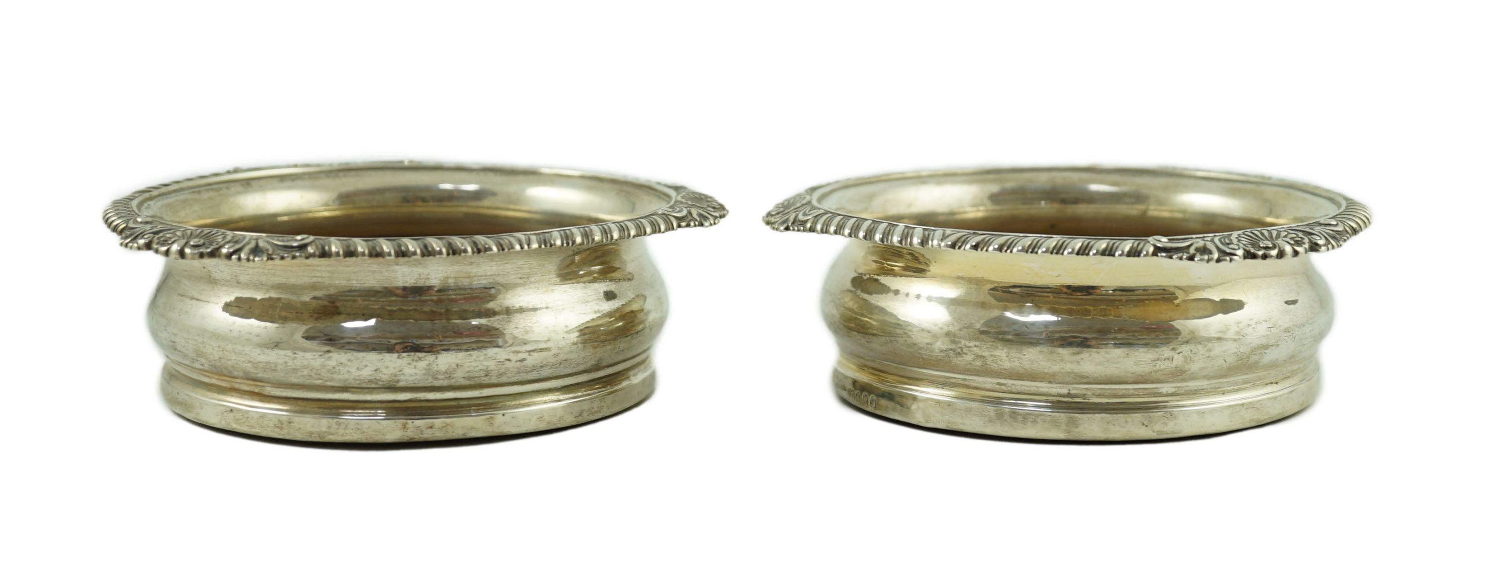 A pair of George IV silver wine coasters by Benjamin Smith III